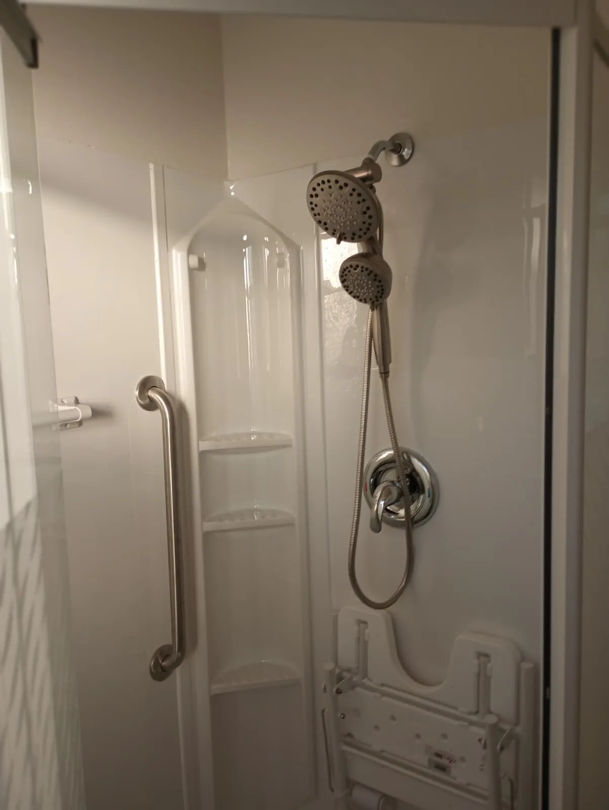 Accessible walk-in shower with grab bar and fold-down seat